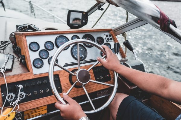 Captain at the helm of an old yacht, dashboard