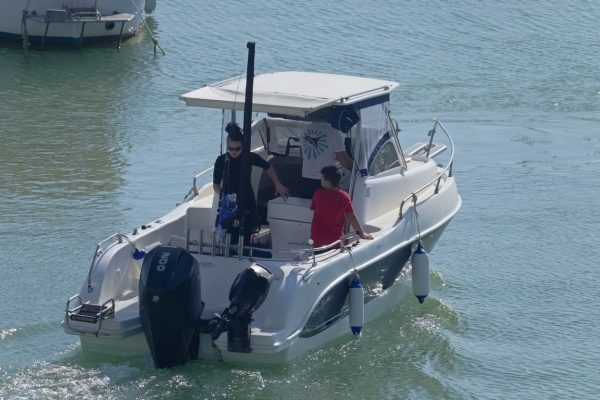 Italy, Sicily, Mediterranean Sea, Marina di Ragusa (Ragusa Province); 5 October 2020, people on a motor boat in the port - EDITORIAL